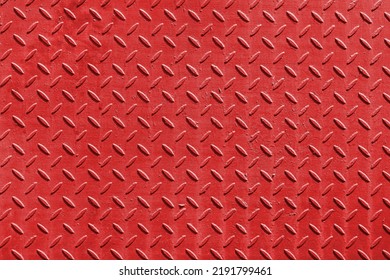 Red metal surface with diamond plate texture. The diamond steel metal sheet.  Pattern of old metal diamond plate