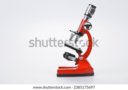 Red Microscope on Grey Background