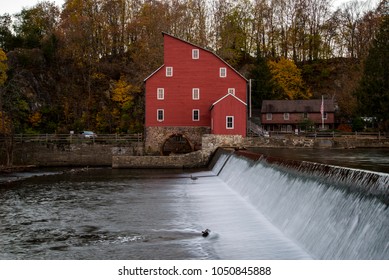 A Red Mill with a waterfall