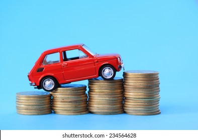 Red Miniature Car On Coin Stack