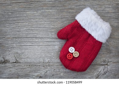 Red Mitten On Wooden Background