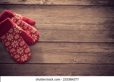 red mittens on wooden background