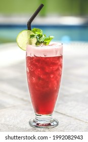 A Red Mocktail With Mint Leaves, Lemon And Crushed Ice.