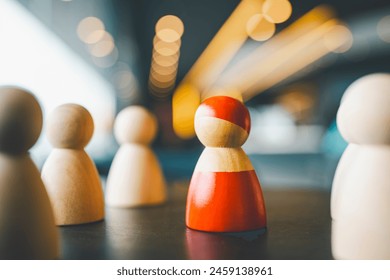 The red model is separated from the group of other models. The concept of workplace bullying, socializing, cooperation at work is a problem. - Powered by Shutterstock