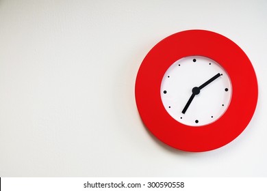 Red Modern Wall Clock On White Concrete Wall