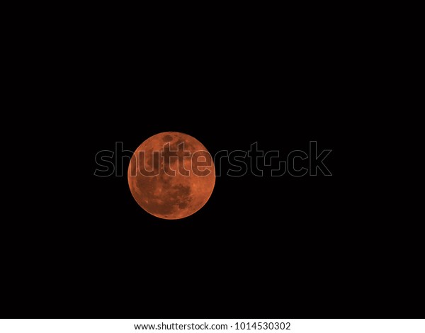 Red moon in\
darkness sky, Red lunar\
eclipse.