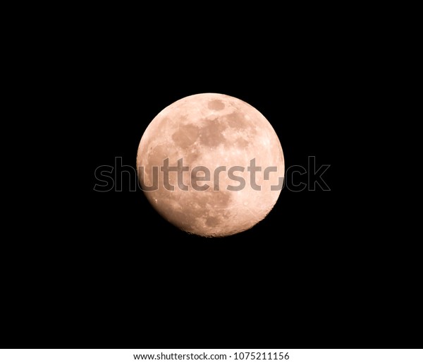Red moon on a black\
background at night