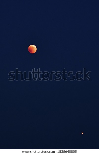 the red moon in the\
starry sky with mars
