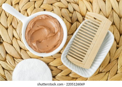 Red Moroccan Bentonite Clay In A Small White Bowl And Wooden Hairbrush. Diy Facial Or Hair Mask, Body Wrap Recipe. Natural Beauty Treatment And Spa. Top View. 