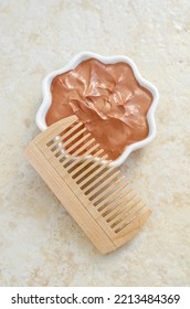 Red Moroccan Bentonite Clay In A Small White Bowl And Wooden Hairbrush. Diy Facial Or Hair Mask, Body Wrap Recipe. Natural Beauty Treatment And Spa. Top View. 