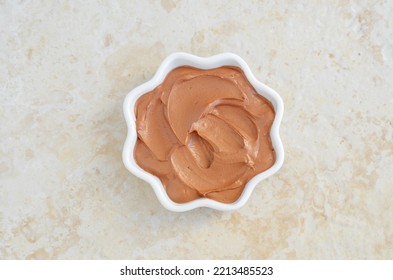 Red Moroccan Bentonite Clay In A Small White Bowl. Diy Facial Or Hair Mask, Body Wrap Recipe. Natural Beauty Treatment And Spa. Top View. 