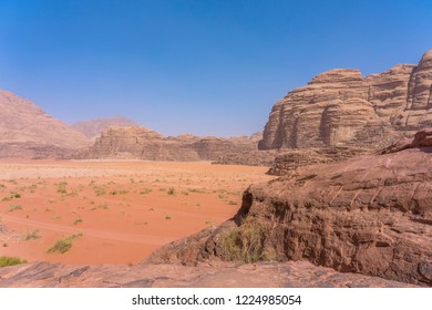 Red mountains of Wadi Rum desert in Jordan. Wadi Rum also known as The Valley of the Moon is a valley cut into the sandstone and granite rock in southern Jordan to the east of Aqaba - Shutterstock ID 1224985054