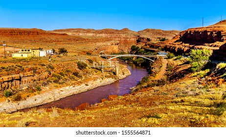 The Red Muddy San Juan River As It Flows Through The Red Sandstone Landscape Past The Settlement Of Mexican Hat At The Northern Edge Of The Navajo Nation's Borders In Southern Utah, United States