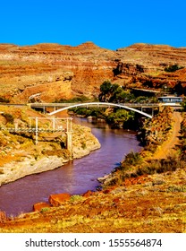 The Red Muddy San Juan River As It Flows Through The Red Sandstone Landscape Past The Settlement Of Mexican Hat At The Northern Edge Of The Navajo Nation's Borders In Southern Utah, United States