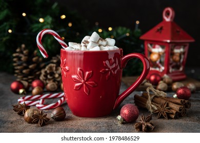 Red mug with hot chocolate, marshmallows and candy cane on  dark background  for Christmas holiday - Powered by Shutterstock