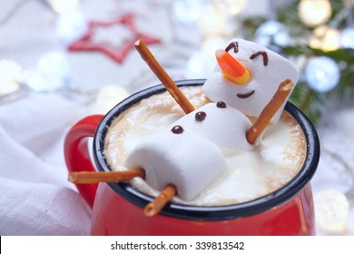 Red mug with hot chocolate with melted marshmallow snowman - Shutterstock ID 339813542