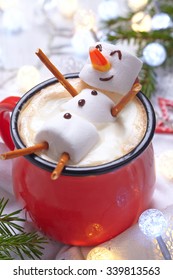 Red mug with hot chocolate with melted marshmallow snowman - Shutterstock ID 339813563