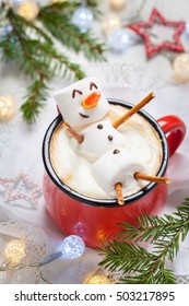 Red mug with hot chocolate with melted marshmallow snowman - Shutterstock ID 503217895