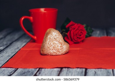 red mug red napkin paper cupcake on the table rose