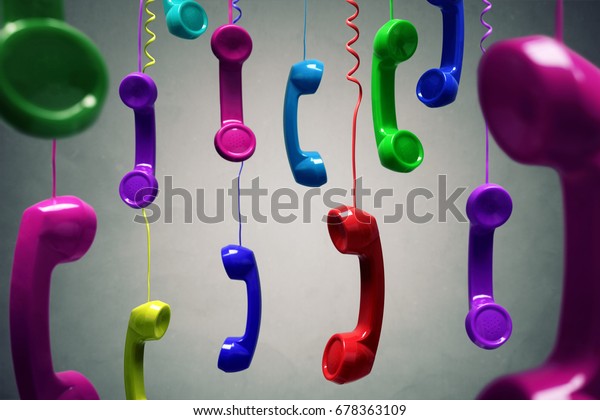 Red and multi-coloured telephone receiver hanging over\
gray background concept for on the phone, customer service, on hold\
or contact us
