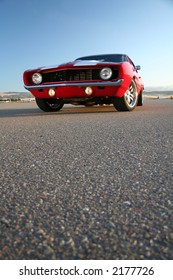 Red Muscle Car Camaro And Asphalt At Ground Level