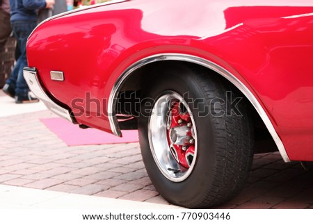 Red muscle car front wheel chromes