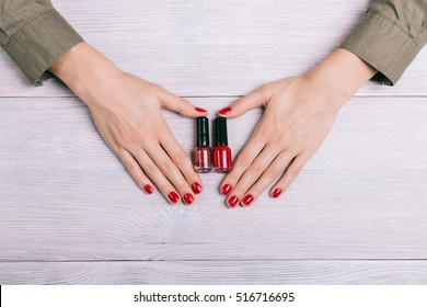 Red nail polish and female hands with manicure, top view - Powered by Shutterstock