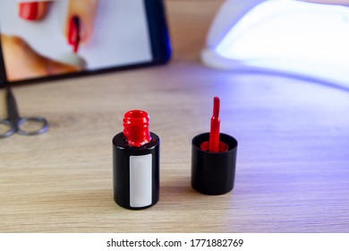 Red Nail Polish. Mobile Phone, Ultraviolet Lamp.