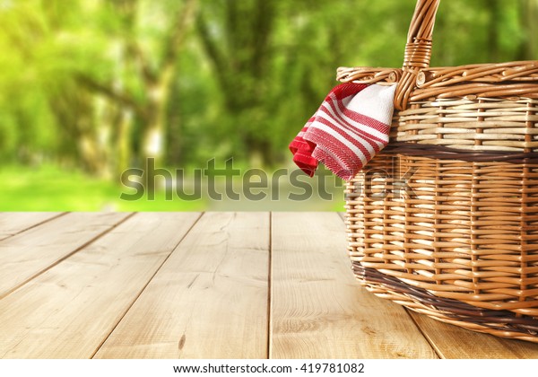 red napkin picnic\
basket and table place 