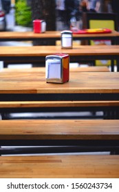 Red Napkin Ring Among Many Wooden Tables