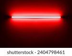 Red neon lamp on a white wall for design