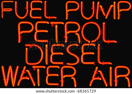 Red neon sign of petrol station services.
