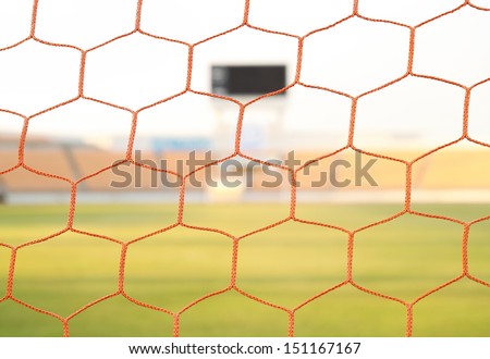 red net soccer goal football and green grass field in stadiun