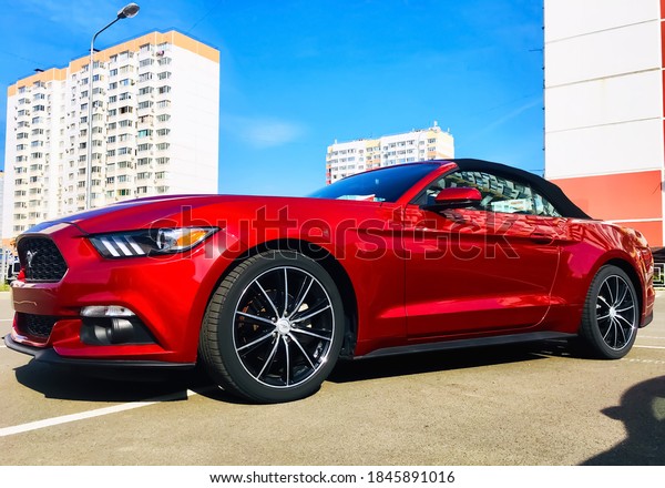 \
red new mustang at the exhibition on the\
background, Russia, Krasnodar,\
04.10.2020