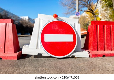 Red no entry traffic sign on the closed road in the city street. City road under construction. Roadway closed - Shutterstock ID 2106471008