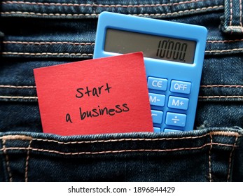 Red note and blue calculator in jeans pocket written START A BUSINESS , concept of a new small business owner calculating the startup cost  to launch business on their own
