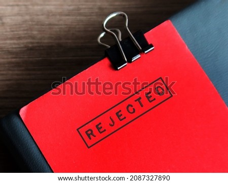 Red note clip with document with text stamp REJECTED, concept of to refuse to accept or use the idea or work, not given approval or acceptance to plan, application or project