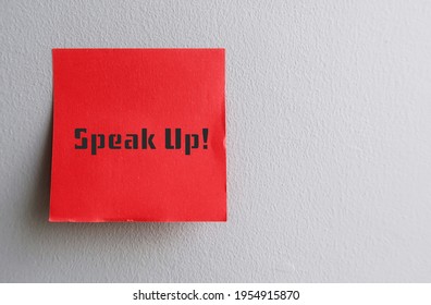 Red Note On Copy Space Gray Wall With Text SPEAK UP ! , Self Reminder To Raise Voice Louder Or Dare To Express Opinion Frankly And Openly , Stand Up For Yourself