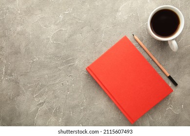 Red notebook with coffee cup and pencil on grey background. Flat lay, creative workspace office. Business-education concept with copy space. Top view - Powered by Shutterstock