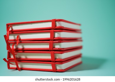 Red notebook on a green table.