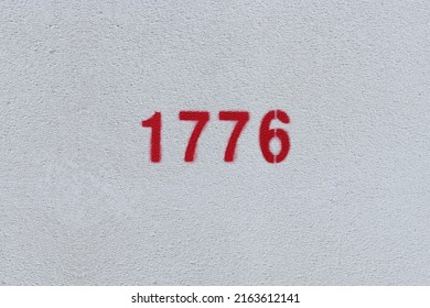 Red Number 1776 On The White Wall. Spray Paint.
