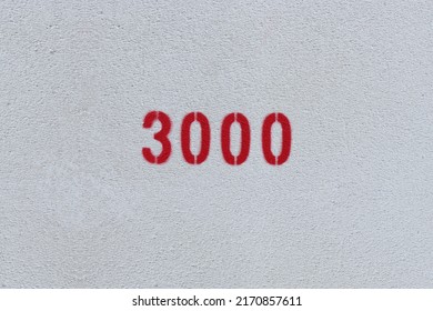 Red Number 3000 On The White Wall. Spray Paint.
