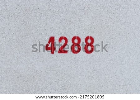 Red Number 4288 on the white wall. Spray paint.
