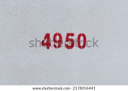 Red Number 4950 on the white wall. Spray paint.
