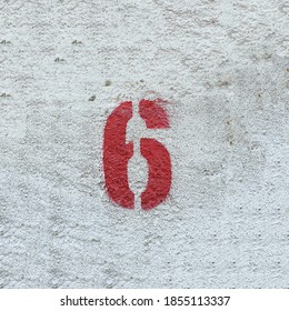 Red Number 6 on the white wall . Spray paint. - Powered by Shutterstock