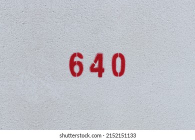 RED Number 640 on the white wall. Spray paint.