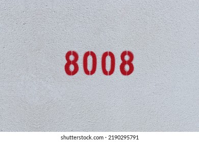 Red Number 8008 on the white wall. Spray paint.