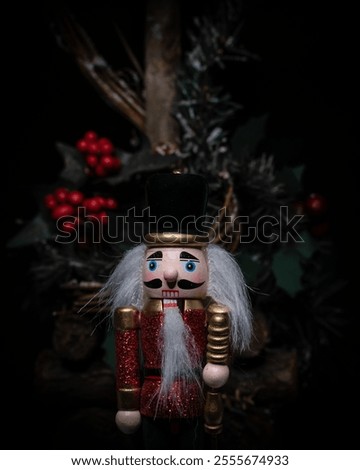 Red nutcracker with mistletoe, isolated on black background