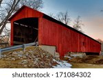 The red Oakalla Covered Bridge is a wooden, single span burr arch structure built in 1898 near Greencastle, Indiana.