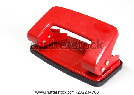 Red office paper hole puncher isolated on white background